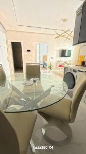 a glass table and chairs in a living room at La costa KOala in Tangier +12 photos