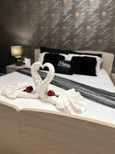 two swans making a heart on a bed at Couple's Getaway in Is-Swieqi
