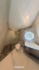 a bathroom with a toilet and a sink and a mirror at La costa KOala in Tangier