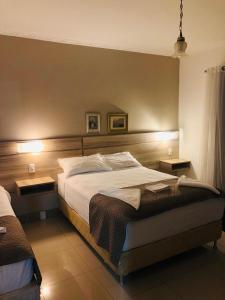 a bedroom with a large bed and two night stands at Hotel Quinta da Bica D'Água in Florianópolis +53 photos