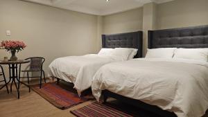 A bed or beds in a room at Amaru TreeHouse