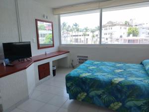 Rúm í herbergi á Hotel Aristos Acapulco