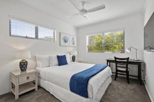 a bedroom with a bed and a desk with a chair at Coastal Luxury at 'Sunshine Central' 3 Bed Penthouse in Sunshine Beach