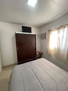 a bedroom with a large bed and a window at Cabaña 32 termas in Chajarí +1 photo