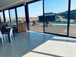 a patio with a table and chairs and a pool at Zimbali Lakes Resort Ocean Club D24 in Ballito