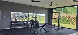 a gym with treadmills and ellipticals in a room at Zimbali Lakes Resort Ocean Club D24 in Ballito