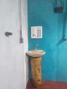 a bathroom with a sink on a blue wall at Camping do edmar in São Roque de Minas