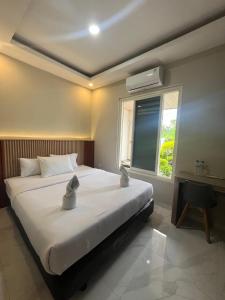 Ένα ή περισσότερα κρεβάτια σε δωμάτιο στο El Nipa Hotel Labuan Bajo