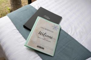 a book sitting on top of a bed at Rocky Creek Escape by Tiny Away in Kanighan
