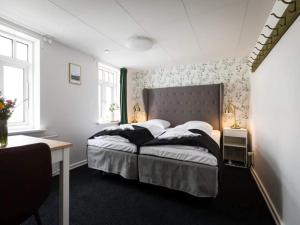 a bedroom with a bed and a desk in it at Romantic 2 person holiday home in Give in Give