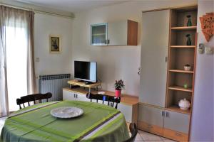 a living room with a bed and a television at Apartment Eni in Rovinj