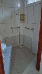a bathroom with a shower and a toilet at Pousada Vida & Brisa in Pelotas