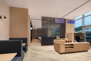 a waiting room with tables and chairs and windows at Holiday Inn Express Suzhou East Taihu by IHG in Suzhou