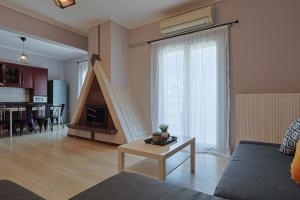 a living room with a couch and a table at John's Luxury Apartment in Paralia Katerinis