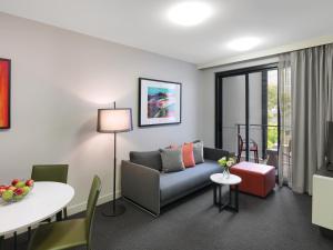 a living room with a couch and a table at Adina Apartment Hotel Sydney Airport in Sydney