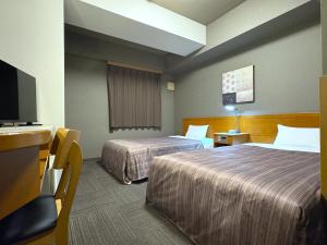 Postel nebo postele na pokoji v ubytování Hotel Route-Inn Honjo Ekiminami + 29 fotografií
