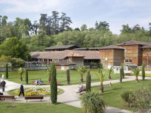 a park with people sitting on benches and trees at Maison T3 chaleureuse avec WiFi gratuit, 2 cheminées, 2-4 personnes - FR-1-841-29 in Cazaubon