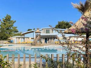 a swimming pool with a slide in front of a house at Maison T3 chaleureuse avec WiFi gratuit, 2 cheminées, 2-4 personnes - FR-1-841-29 in Cazaubon