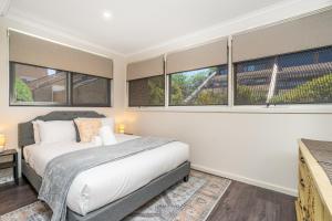 a bedroom with a bed and some windows at 3BR Home near Canberra Hospital and Parliament - Hosted by CanStay in Harman