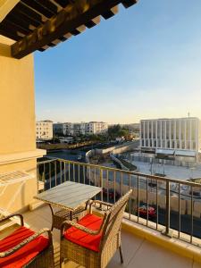 a balcony with a table and chairs and a view of a city at Mivida Emaar New Cairo For Rent in New cairo