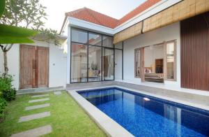 a swimming pool in the backyard of a house at Casa Vana Villas Bali byFaba in Munggu