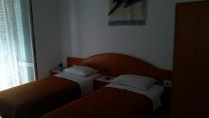 Postel nebo postele na pokoji v ubytování Guesthouse Storelli