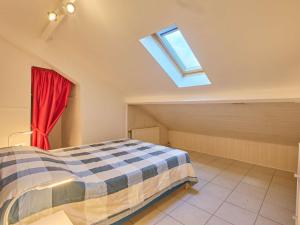 a attic bedroom with a bed and a window at Spacieux T2 à Barbotan avec Parking et Wifi - FR-1-841-51 in Barbotan-les-Thermes +14 photos