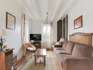 a living room with a couch and a table at Villa rénovée T3 près du lac et thermes - FR-1-841-60 in Cazaubon