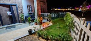 a garden in front of a house at night at فيلا بجوار سينزو مول in Hurghada