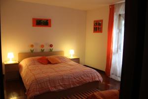 a bedroom with a bed with two lamps on it at La Fattoria Barbini B&B in Viterbo