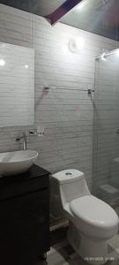 a bathroom with a toilet and a sink and a mirror at MeNTA GLAMPING in Sasaima