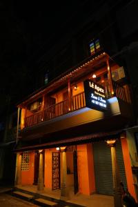 a building with a us hotel sign on it at night at Tharavaadu by Le Apex in Puducherry