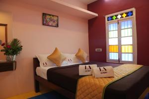 a bedroom with two beds and a window at Tharavaadu by Le Apex in Puducherry