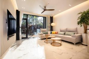 a living room with a couch and a table at Jeju Mare Private Pool Villa in Jeju