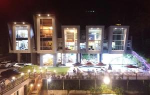 a building with a lot of tables and umbrellas at night at Yangpyeong Blue Hill Pension in Yangpyeong