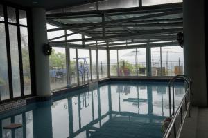 a swimming pool with a slide in a building at Yangpyeong Blue Hill Pension in Yangpyeong +23 photos