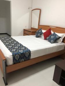 a bedroom with a large bed with a mirror at Summer Villa in Badulla +26 photos