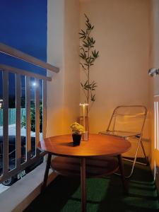 a table with a plant on top of a balcony at Cozy 2BR Condo Near Davao Airport with Samal View in Davao City