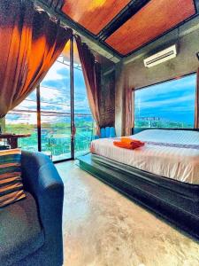 a bedroom with a bed and a large window at Theloft boutique nakhonpanom in Ban Noi Pho Kham