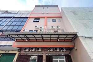 a building with air conditioners on the side of it at Guest House 21 RedPartner in Jakarta