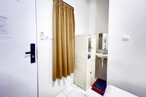 a bathroom with a sink and a shower at Guest House 21 RedPartner in Jakarta