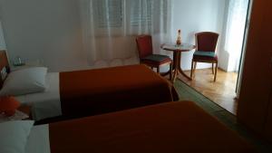 Postel nebo postele na pokoji v ubytování Guesthouse Storelli