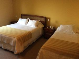 Postel nebo postele na pokoji v ubytování Hotel Patagonia Insular