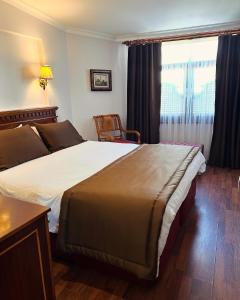 a hotel room with a large bed and a window at Emine Sultan Hotel in Istanbul