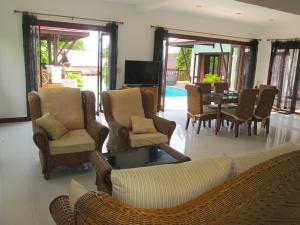 a living room with a couch and chairs and a table at CM8 Beds & Private Pool in Mae Pim