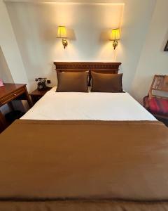 a bedroom with a large bed with two pillows at Emine Sultan Hotel in Istanbul