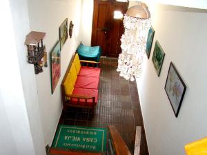 a hallway with chairs and a chandelier at Hotel Casa Vieja in Santa Marta