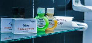 a shelf with two bottles of mouthwash on it at Thilaka City Hotel in Anuradhapura
