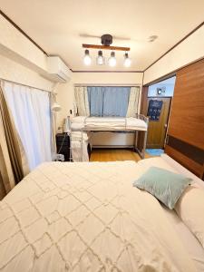 a bedroom with a large white bed in a room at 302Near Ueno Heart of city in Tokyo
