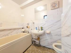 a bathroom with a sink and a tub and a toilet at 302Near Ueno Heart of city in Tokyo +54 photos